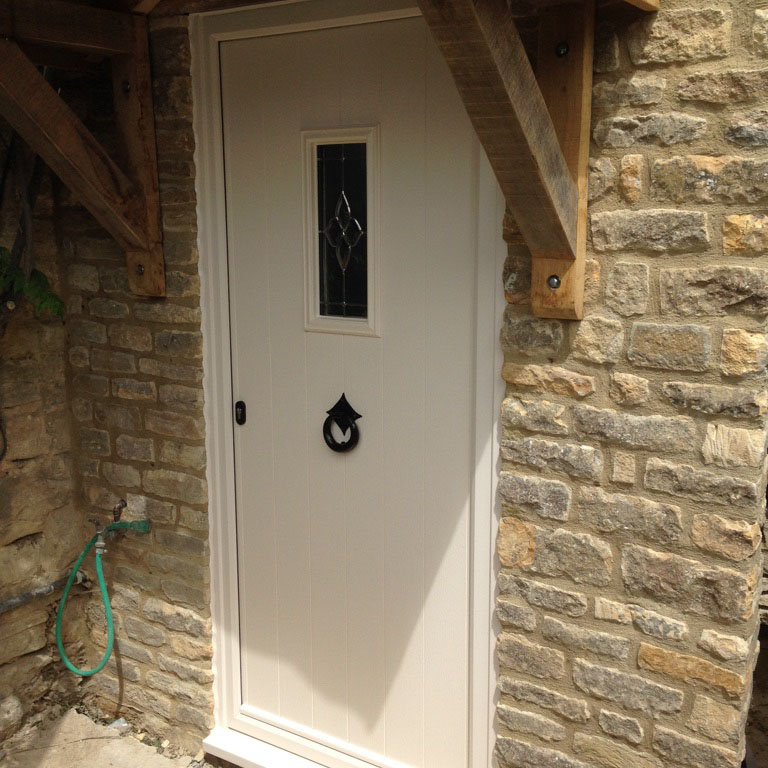 white front door with timber support beams